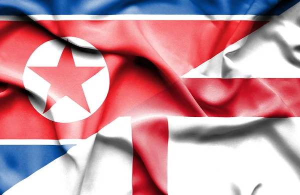 Flagge von England und Nordkorea schwenken — Stockfoto