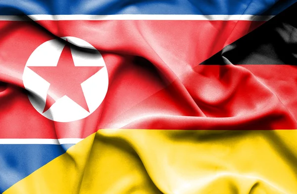 Flagge Deutschlands und Nordkoreas schwenken — Stockfoto
