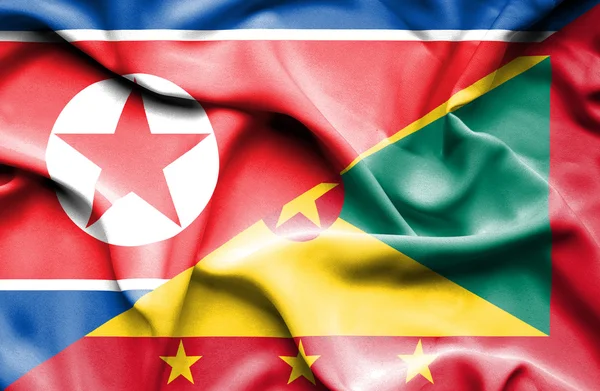 Flagge von Guernsey und Nordkorea schwenken — Stockfoto