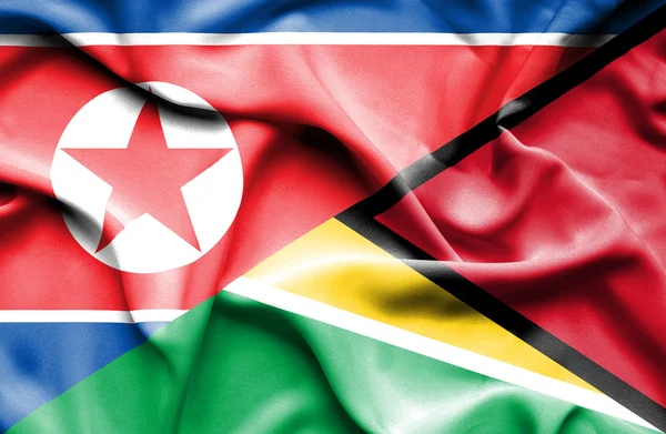 Flagge von Guyana und Nordkorea schwenken — Stockfoto
