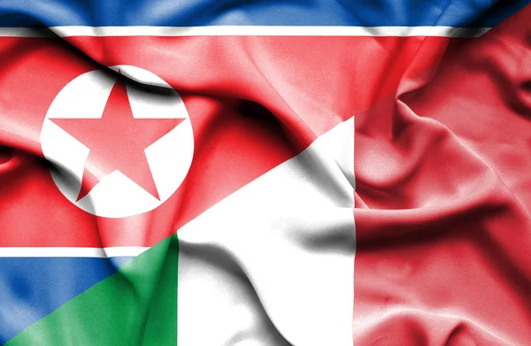 Flagge Italiens und Nordkoreas schwenken — Stockfoto