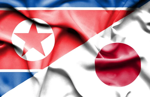 Waving flag of Japan and North Korea