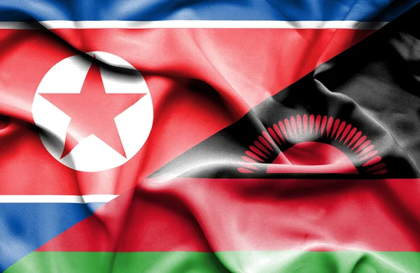 Flagge von Malawi und Nordkorea schwenken — Stockfoto