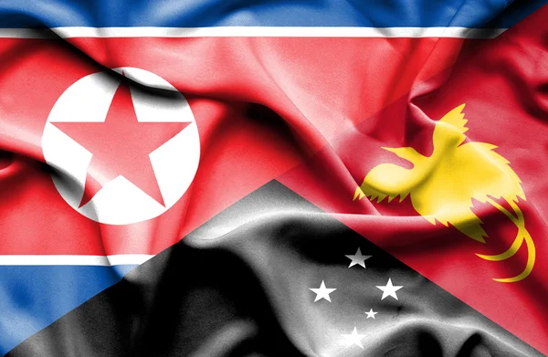 Bandiera sventolante di Papua Nuova Guinea e Corea del Nord — Foto Stock