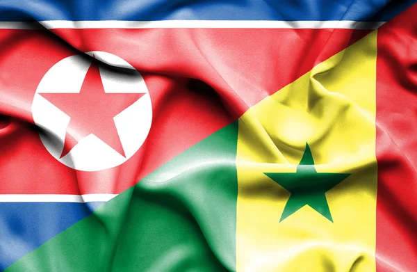 Waving flag of Senegal and North Korea — Stock Photo, Image