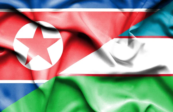 Flagge Usbekistans und Nordkoreas schwenken — Stockfoto