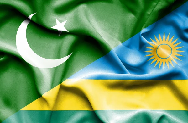 Wapperende vlag van rwanda en pakistan — Stockfoto