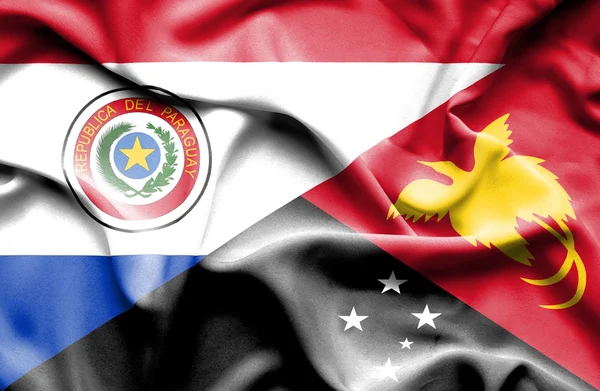 Papua Yeni Gine ve paraguay Cumhuriyeti bayrağı sallayarak — Stok fotoğraf