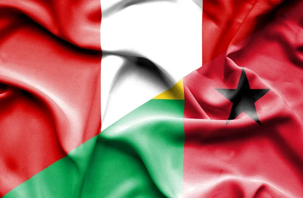 Waving flag of Guinea Bissau and Peru — Stock Photo, Image