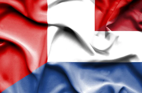 Flagge der Niederlande und Perus schwenken — Stockfoto