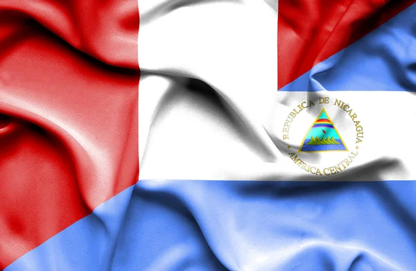 Wapperende vlag van nicaragua en peru — Stockfoto