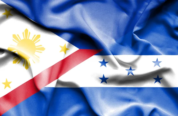 ホンジュラス、フィリピンの旗を振っています。 — ストック写真