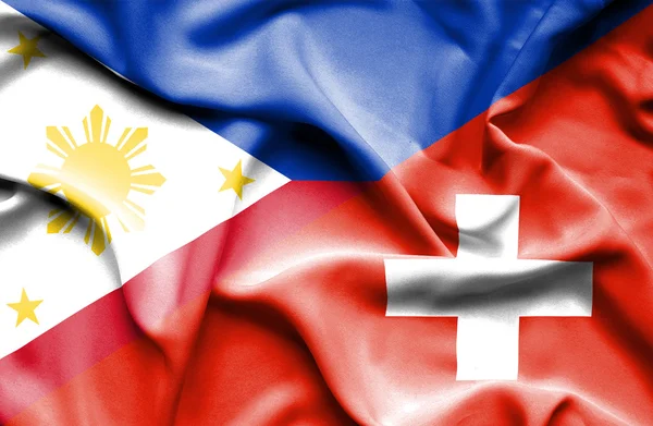 スイス連邦共和国、フィリピンの旗を振っています。 — ストック写真
