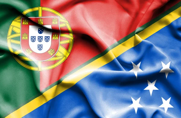 Waving flag of Solomon Islands and Portugal — Stock Photo, Image