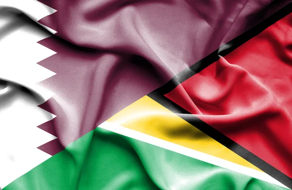 Guyana ve Katar bayrağı sallayarak — Stok fotoğraf