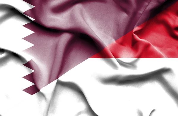 Wapperende vlag van Indonesië en qatarインドネシア、カタールの旗を振っています。 — ストック写真
