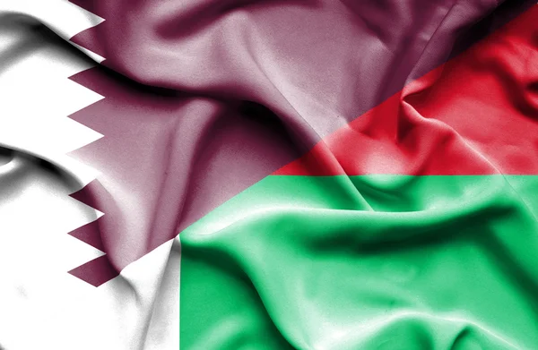 Waving flag of Madagascar and Qatar — Stock Photo, Image
