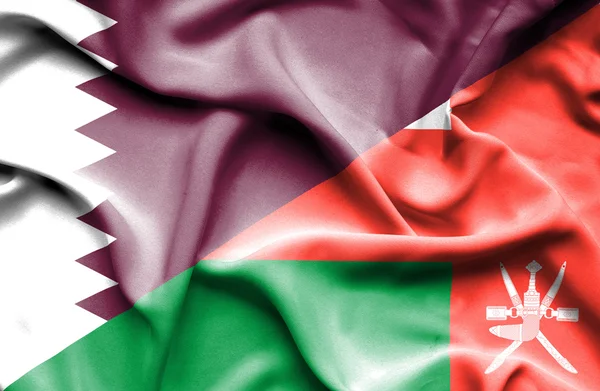 Wapperende vlag van oman en qatar — Stockfoto