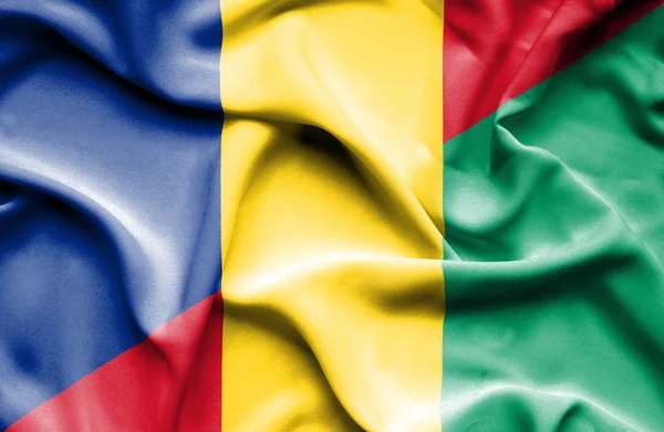 Waving flag of Guinea and Romania — Stock Photo, Image