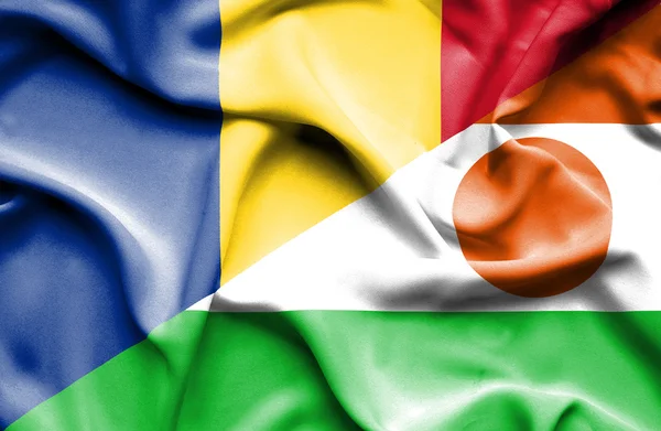 Waving flag of Niger and Romania — Stock Photo, Image