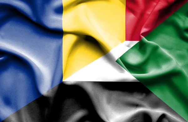 Waving flag of Sudan and Romania — Stock Photo, Image
