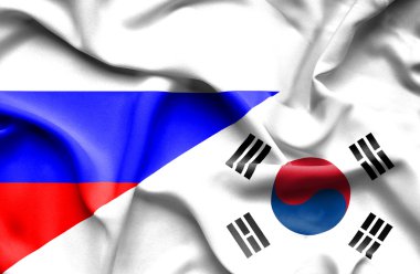 Güney Kore ve Rusya bayrağı sallayarak