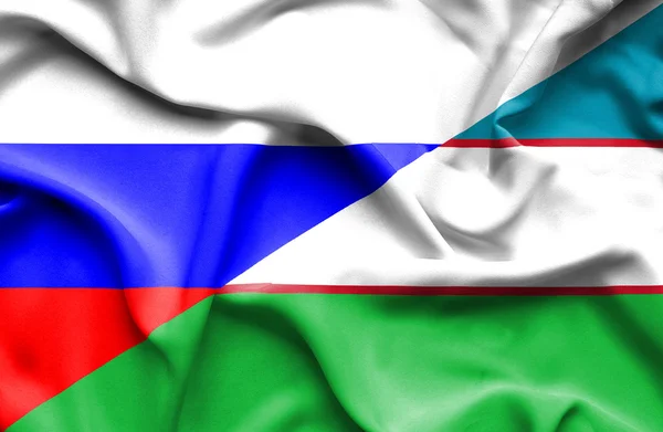 Waving flag of Uzbekistan and Russia — Stock Photo, Image