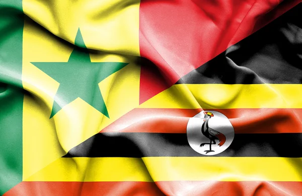 Bandera ondeante de Uganda y Senegal — Foto de Stock