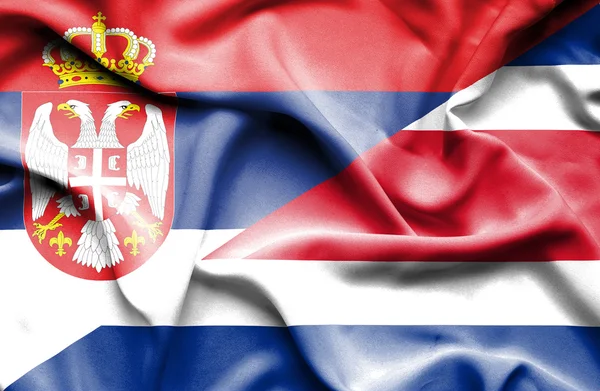 Waving flag of Costa Rica and Serbia — Stock Photo, Image