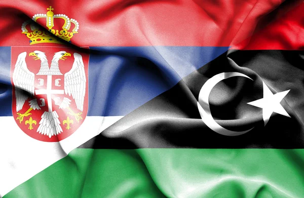 Vlající vlajka Libye a Srbsko — Stock fotografie