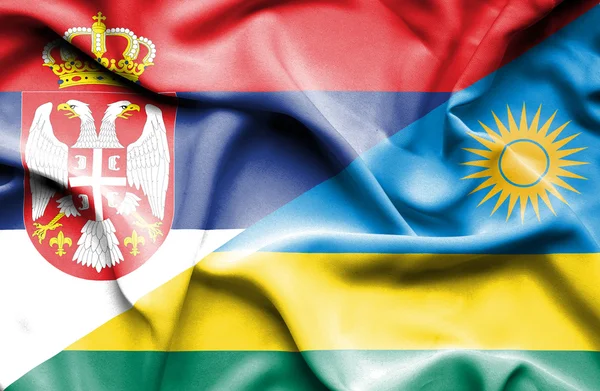 Vlající vlajka Rwandy a Srbsko — Stock fotografie