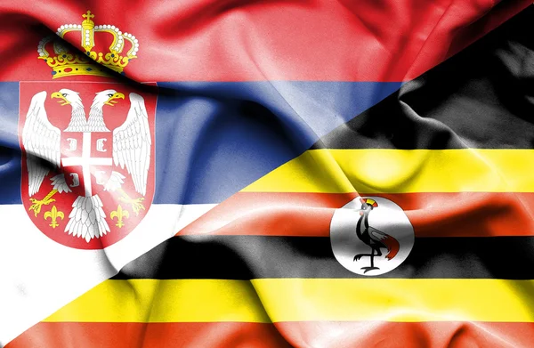 Flagge Ugandas und Serbiens schwenken — Stockfoto