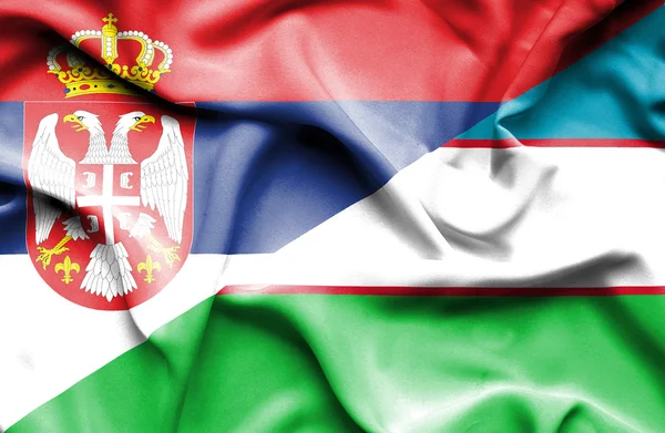Vlající vlajka Uzbekistánu a Srbsko — Stock fotografie