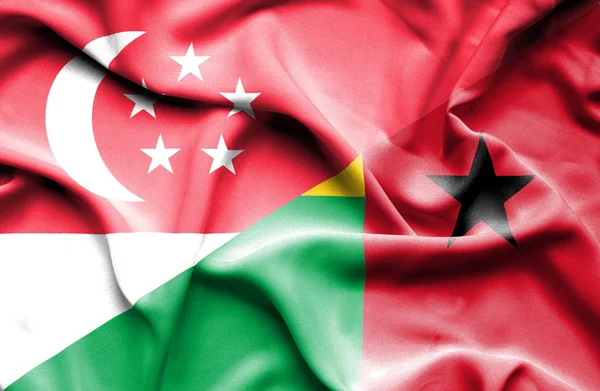 Waving flag of Guinea Bissau and Singapore — Stock Photo, Image