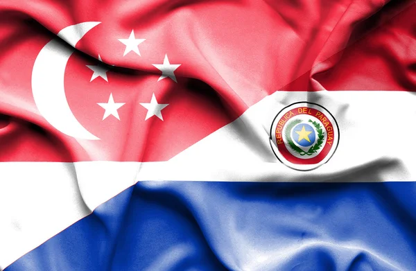 Vlající vlajka Paraguaye a Singapur — Stock fotografie