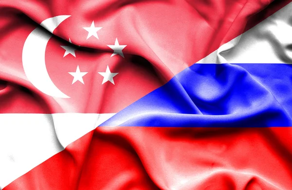 ロシアとシンガポールの旗を振っています。 — Stock fotografie