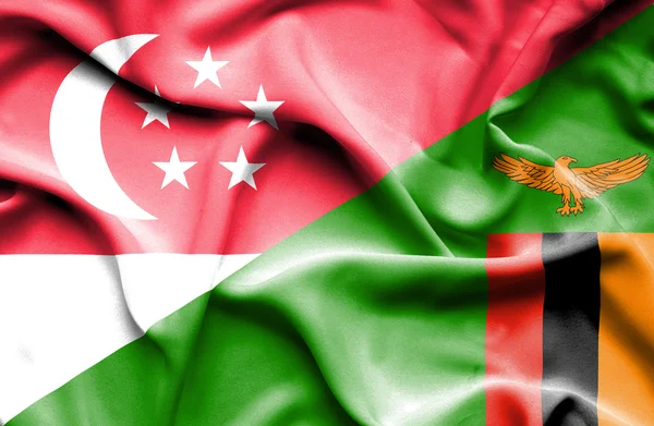 Waving flag of Zimbabwe and Singapore — Stock Photo, Image