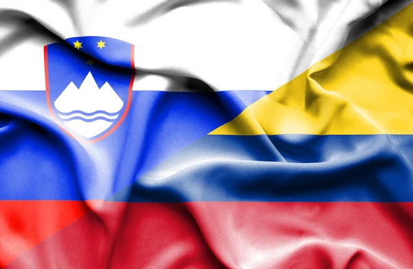 Waving flag of Columbia and Slovenia — Stock Photo, Image