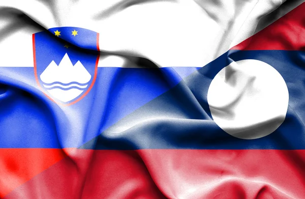 Waving flag of Laos and Slovenia — Stock Photo, Image