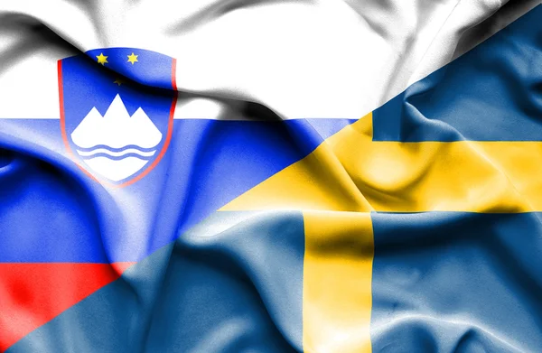 Waving flag of Sweden and Slovenia — Stock Photo, Image