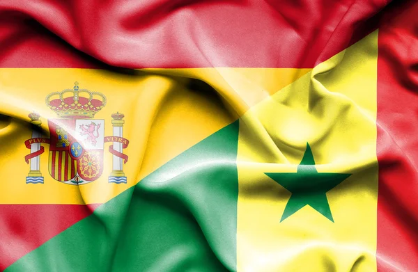 Waving flag of Senegal and Spain — Stock Photo, Image