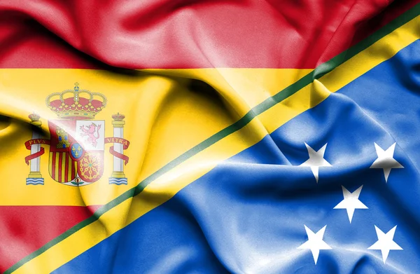 Waving flag of Solomon Islands and Spain — Stock Photo, Image