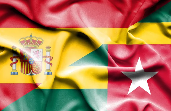 Waving flag of Togo and Spain — Stock Photo, Image