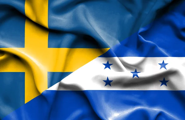 Waving flag of Honduras and Sweden — Stock Photo, Image