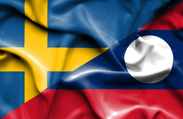 Viftande flagga laos och Sverige — Stockfoto