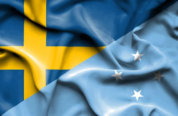 Flagge von Mikronesien und Schweden schwenkend — Stockfoto