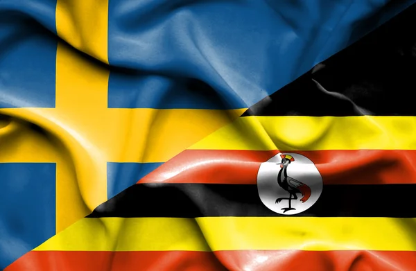 Flagge Ugandas und Schwedens schwenken — Stockfoto