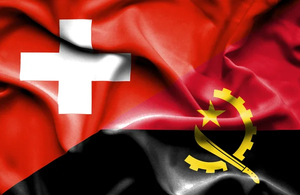 Waving flag of Angola and Switzerland — Stock Photo, Image