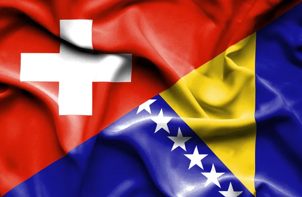 Bosnien och Hercegovina och Schweiz viftande flagga — Stockfoto