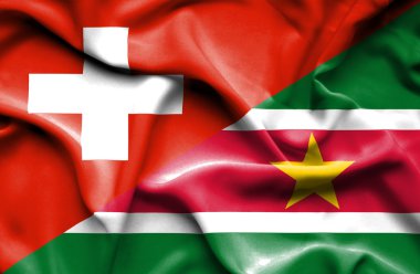 Surinam ve İsviçre bayrağı sallayarak